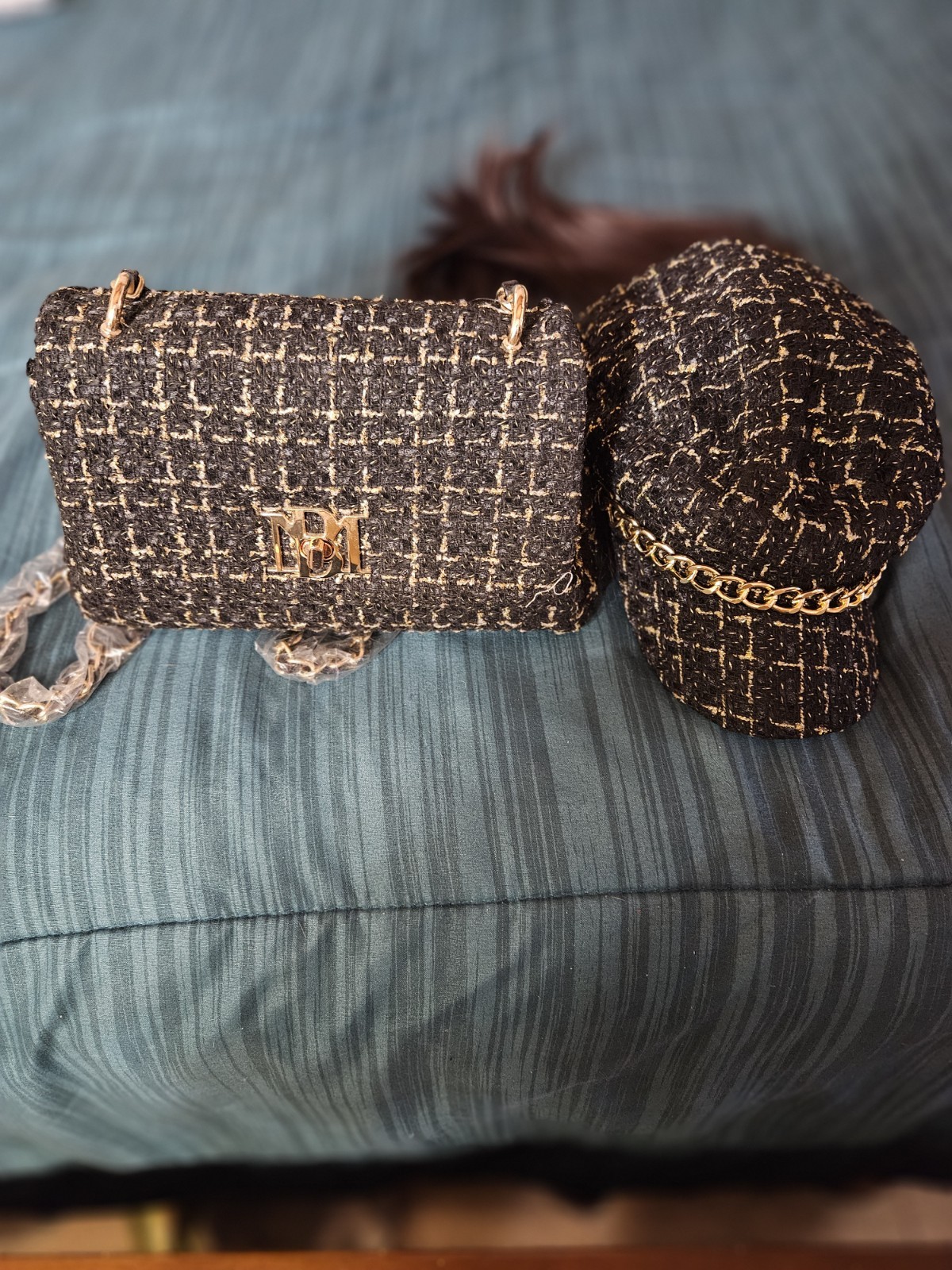 Set of Bradgley Mischka croosbody bag and unbranded hat with wig attached to it.