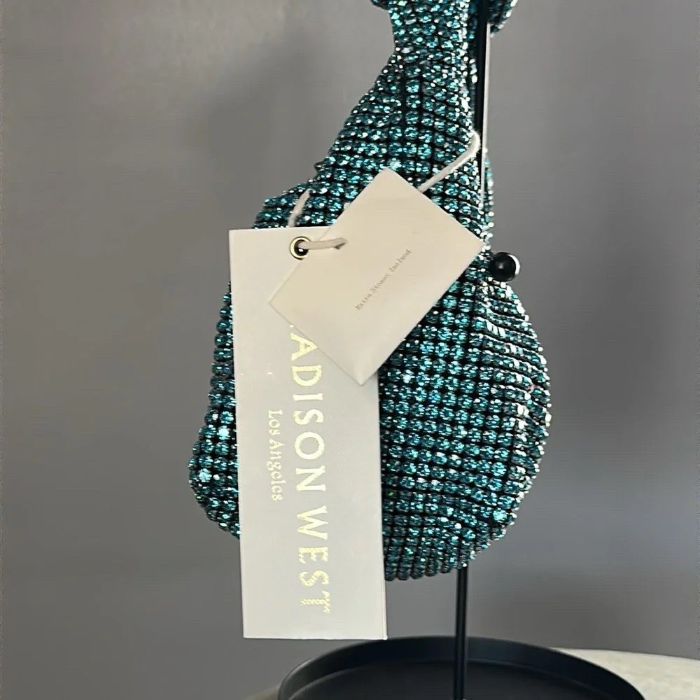 Madison West aqua knotted rhinestone dumpling handbag