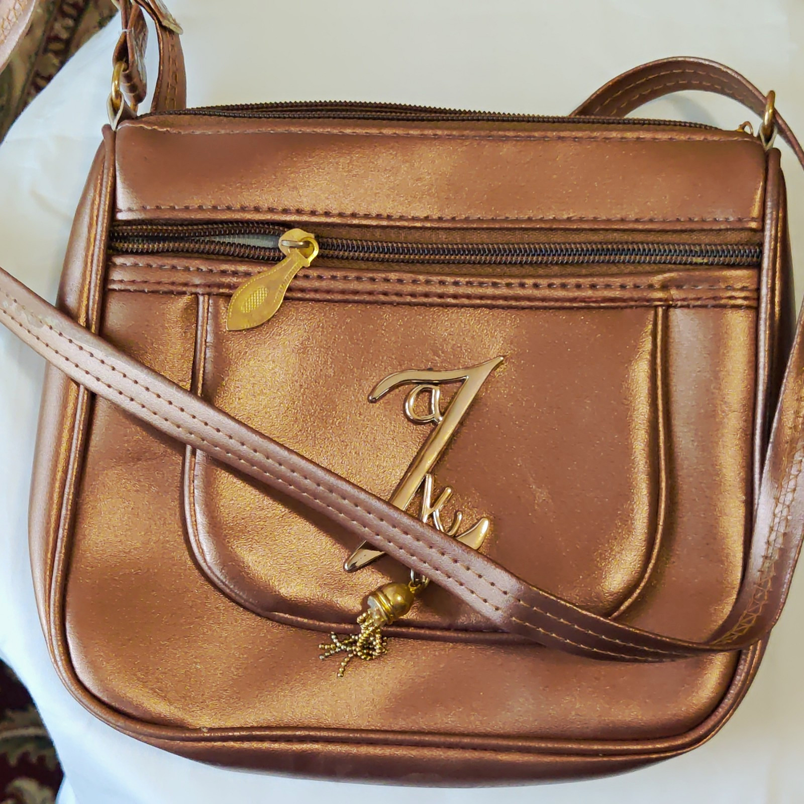 Women’s Bronze Metallic Crossbody Bag Zip Closure Outer Pockets Lined Gold Charm