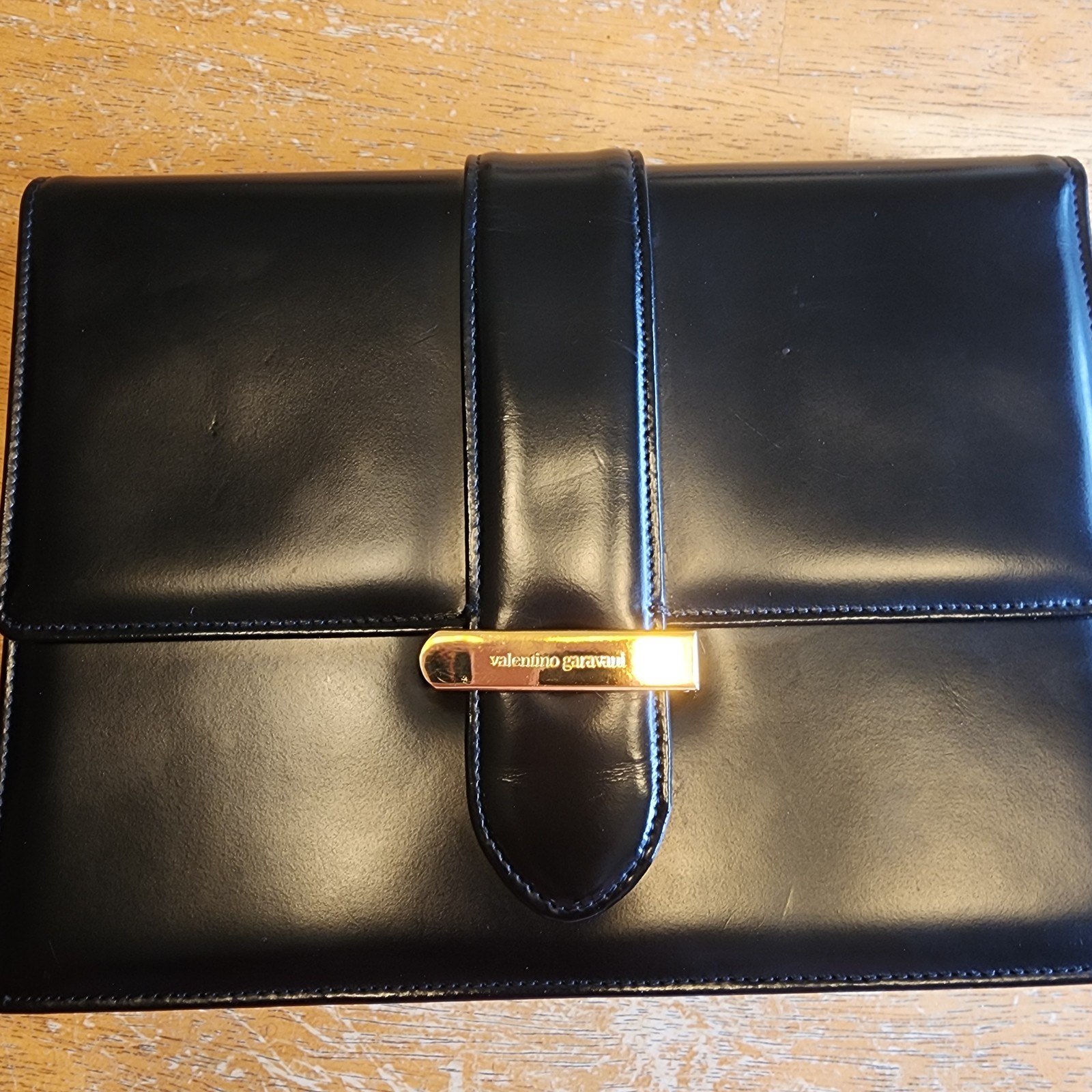 Valentino Garavani Vain clutch bag in black shiny calfskin leather