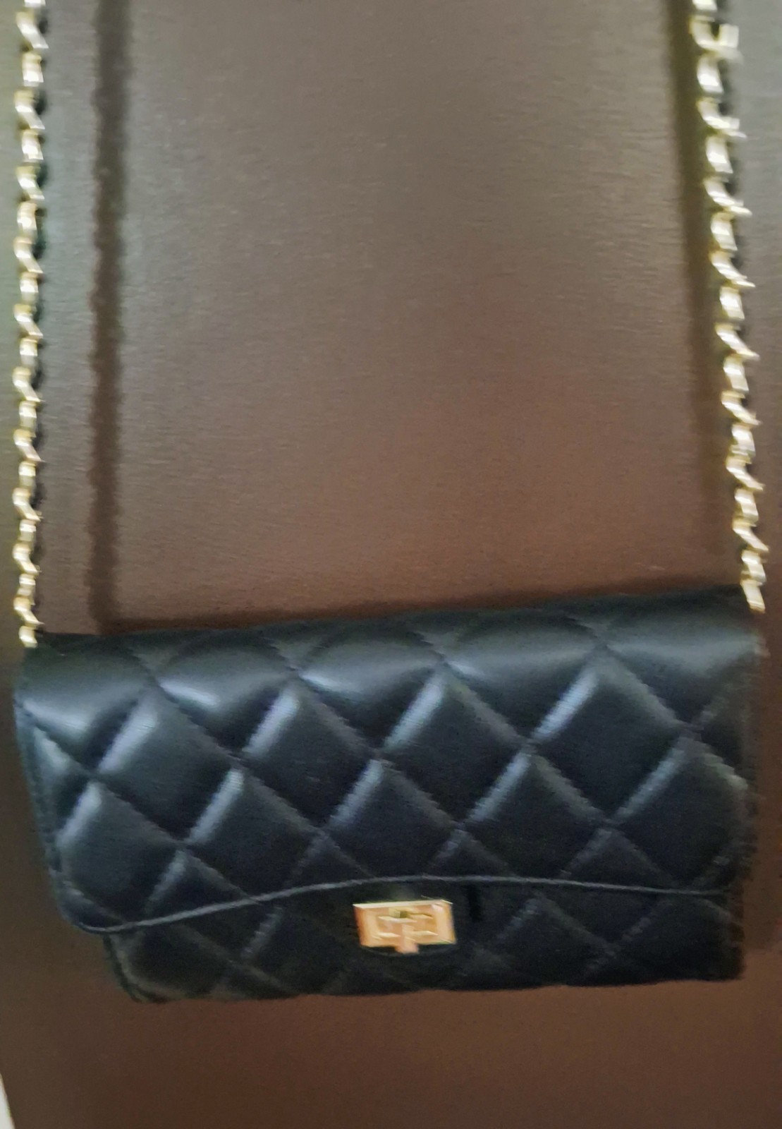 Black crossbody bag with gold tone chain