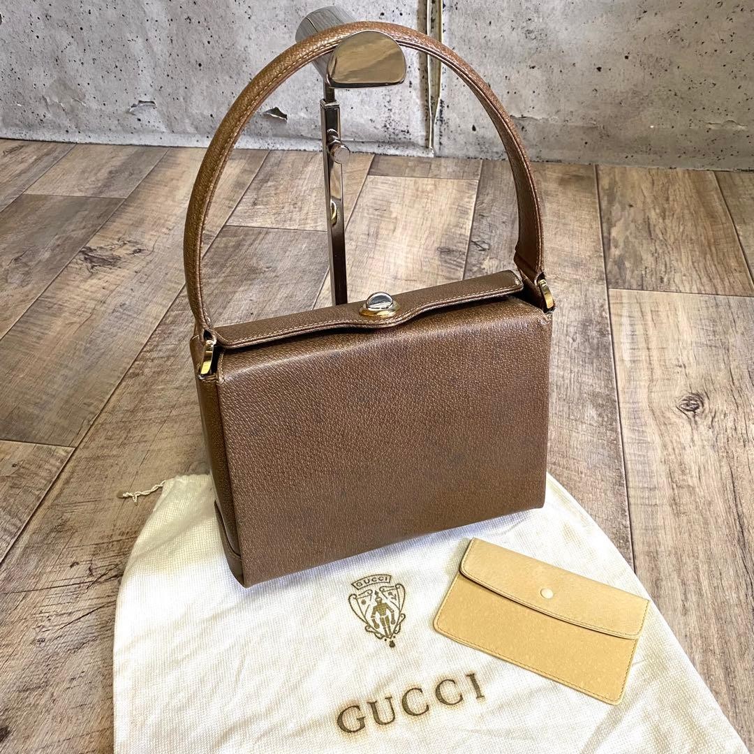 GUCCI Handbag Brown Leather Turn-lock Closure Size: WxH7 in. Strap: 18.9″