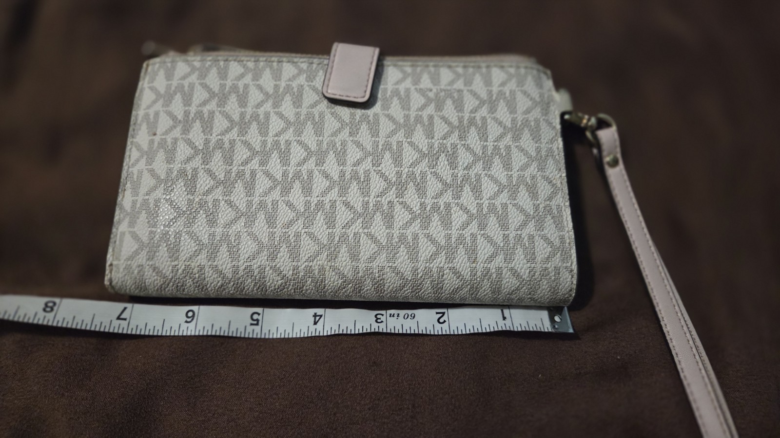 Michael Kors Jet Set Travel wristlet features the signature logo PVC monogram