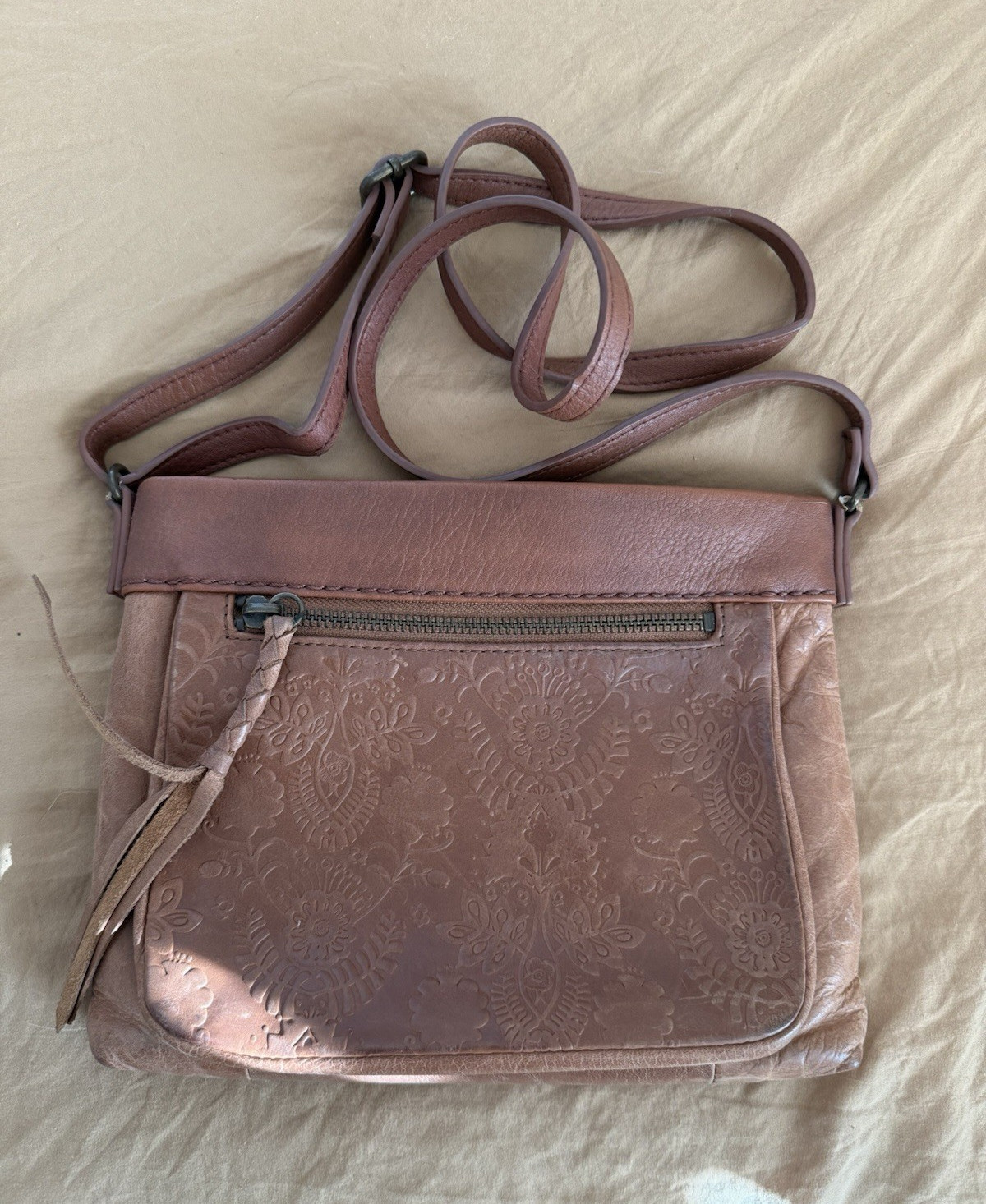 The Sak Brown Floral Crossbody Bag. This purse has been well loved.