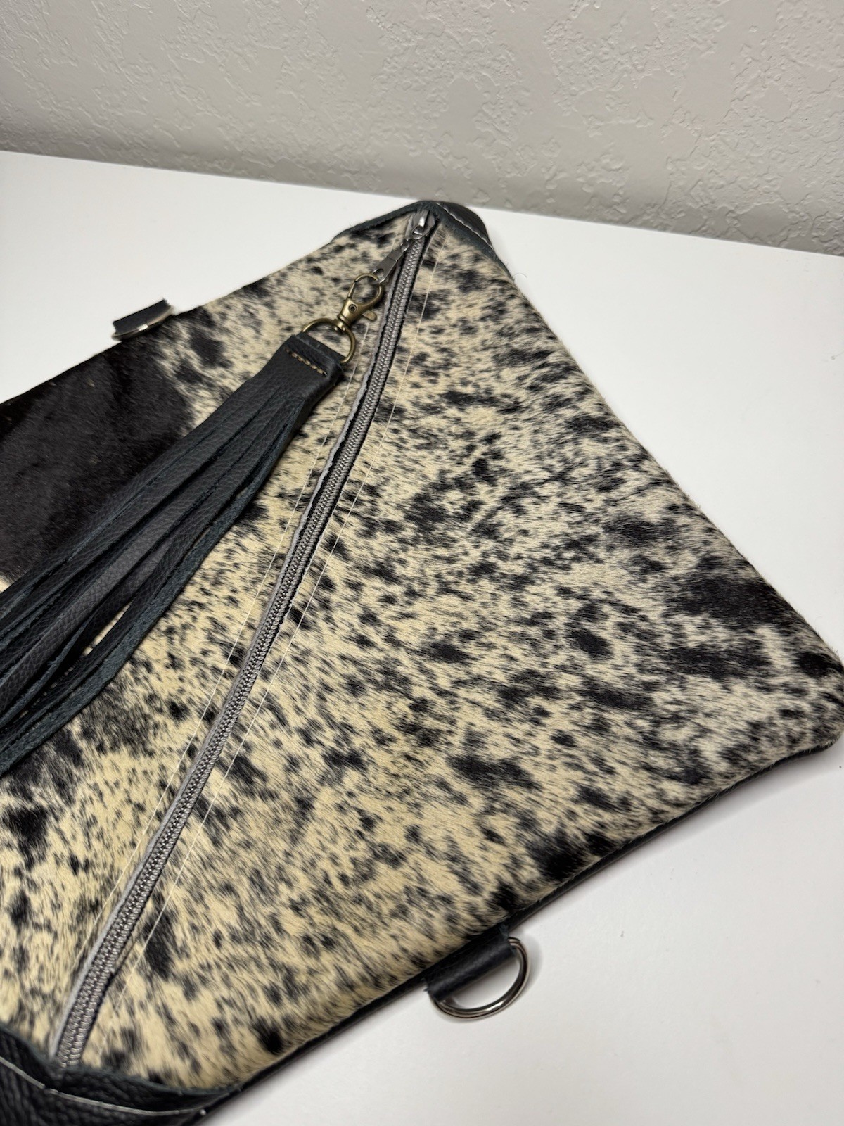 Dancing Cactus Designs Cowhide Print Leather Cosmetic Bag Tassel & Zip Closure