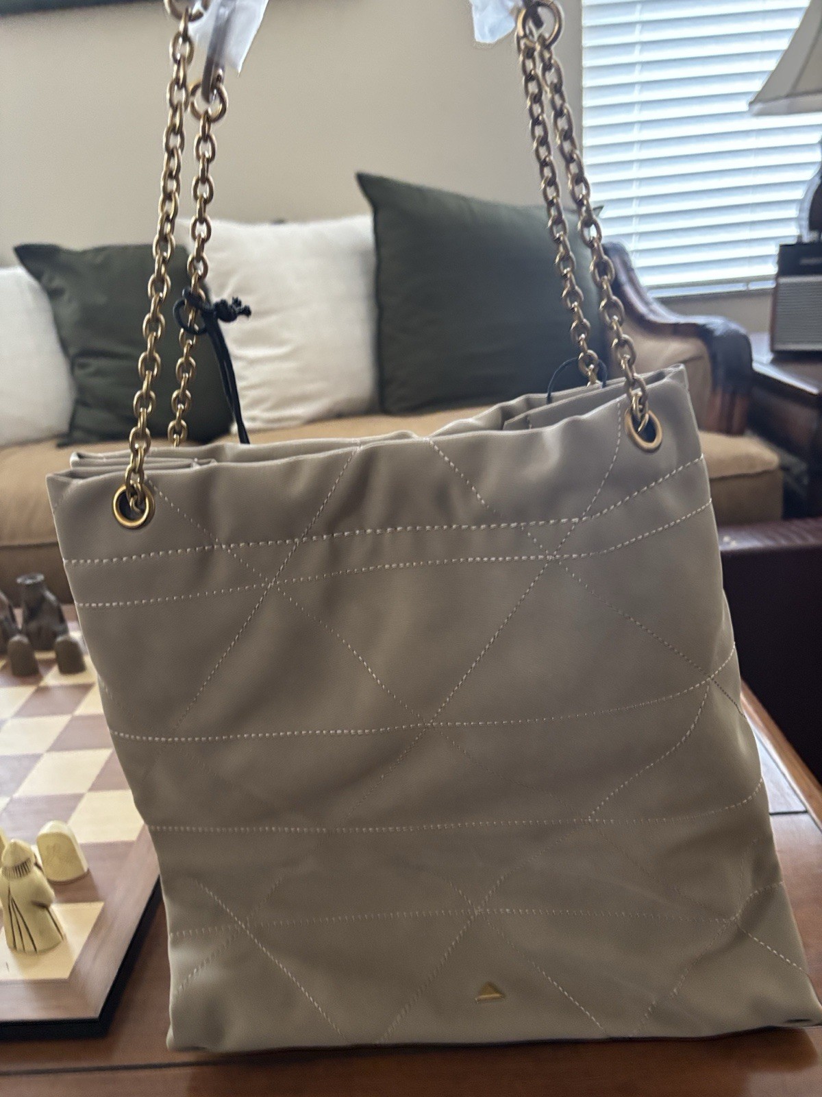 Aldo Morgane bag is a quilted taupe tote featuring gold-toned chain straps.