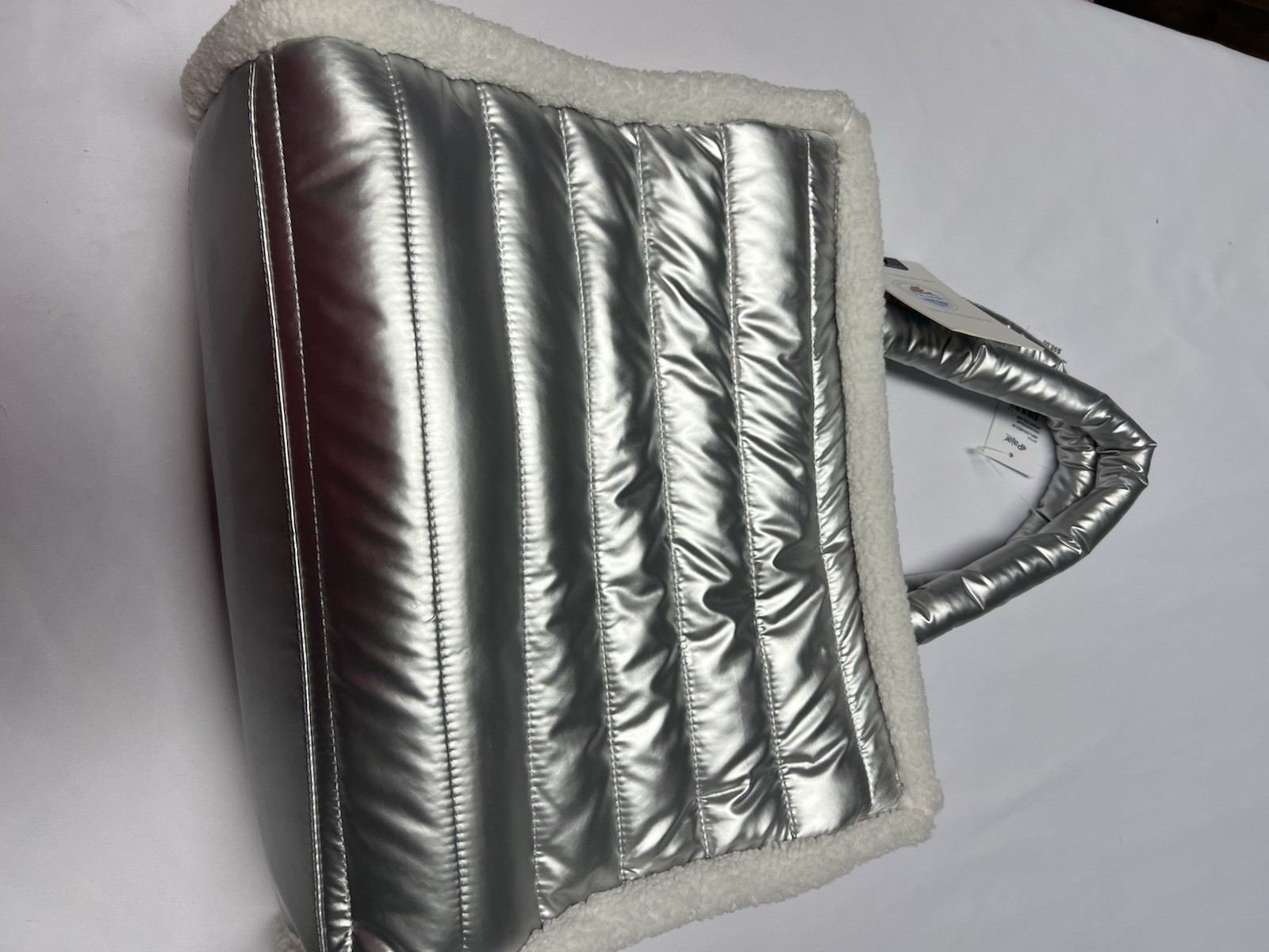 The Pajar 1963 Shearling Puffy Tote is a metallic silver quilted bag NWT