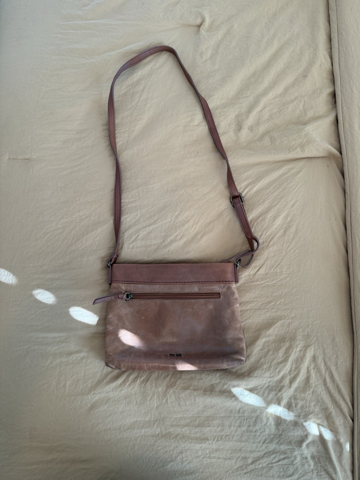 The Sak Brown Floral Crossbody Bag. This purse has been well loved.