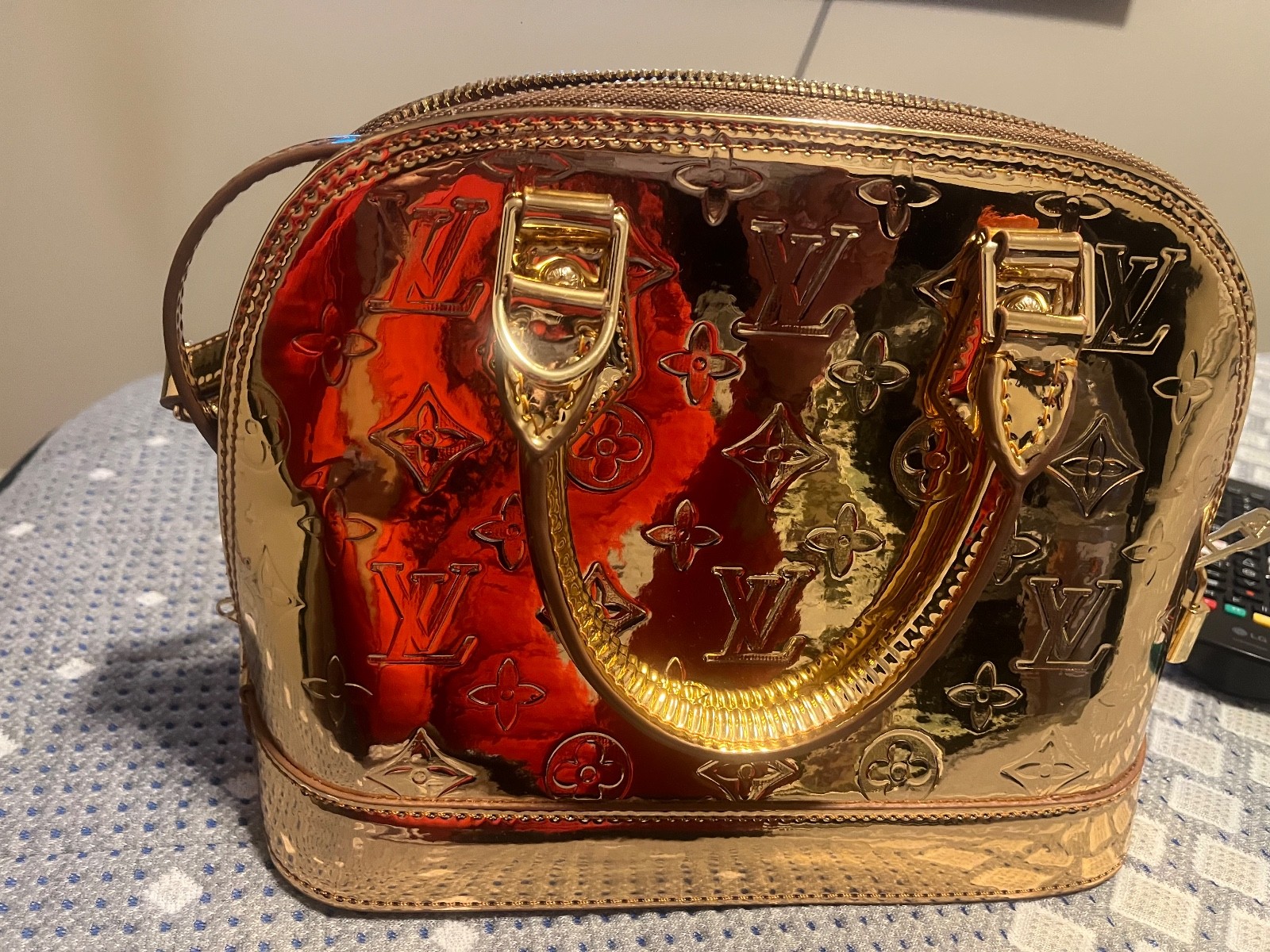 Louis Vuitton Alma Monogram Miroir (Gold Mirror) bag.