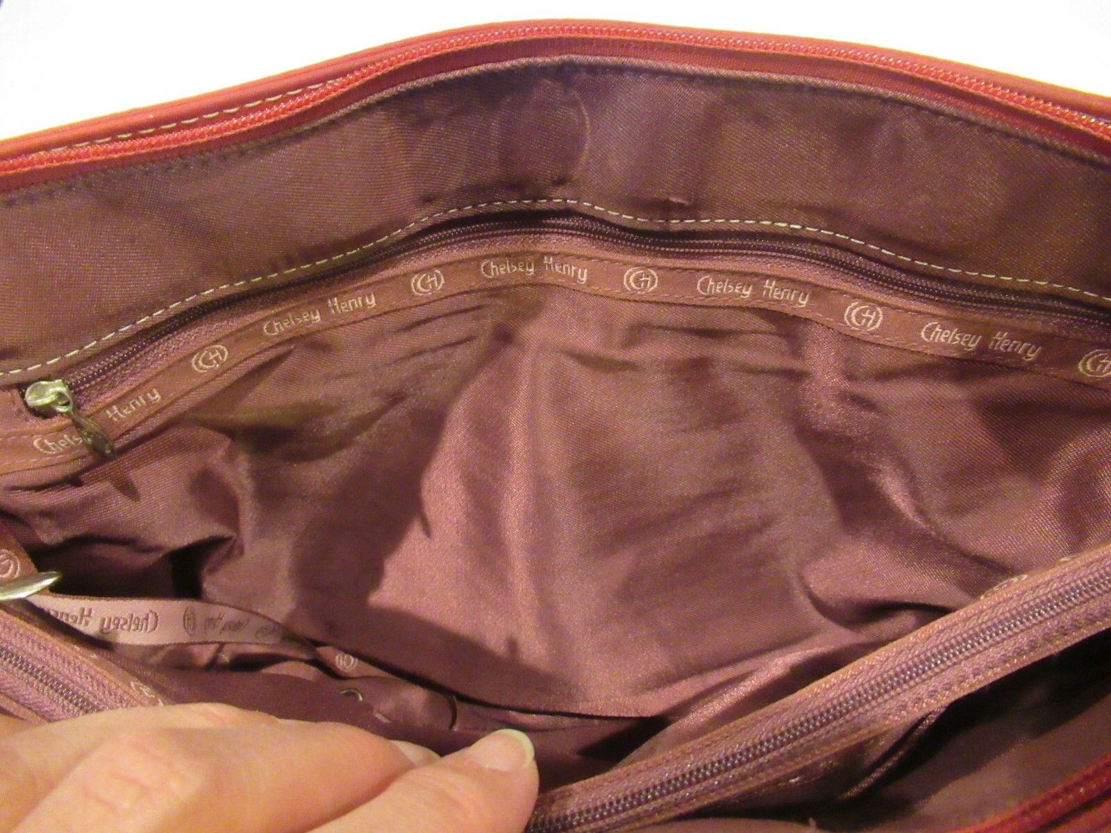 Chelsey Henry red purse with black trim, lots of pockets