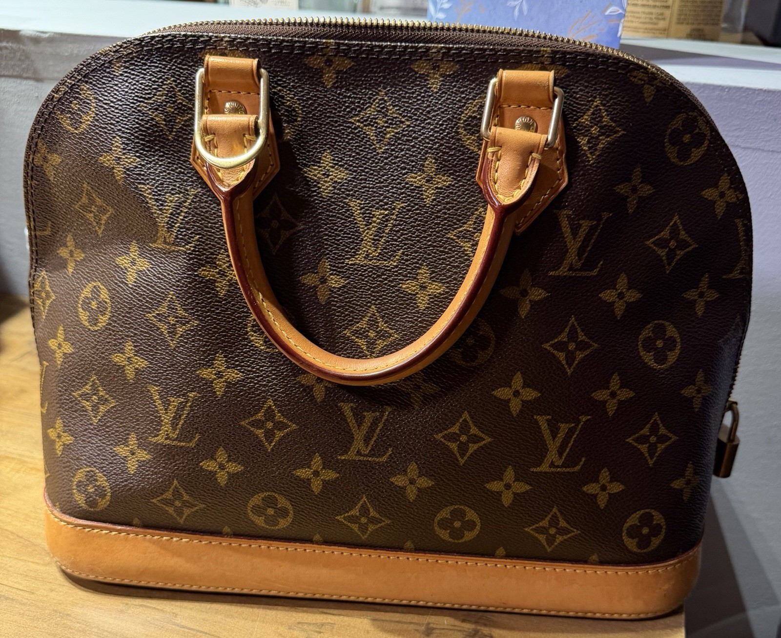 Louis Vuitton Monogram Alma Brown Satchel Top Handle Zip Clochette Gold