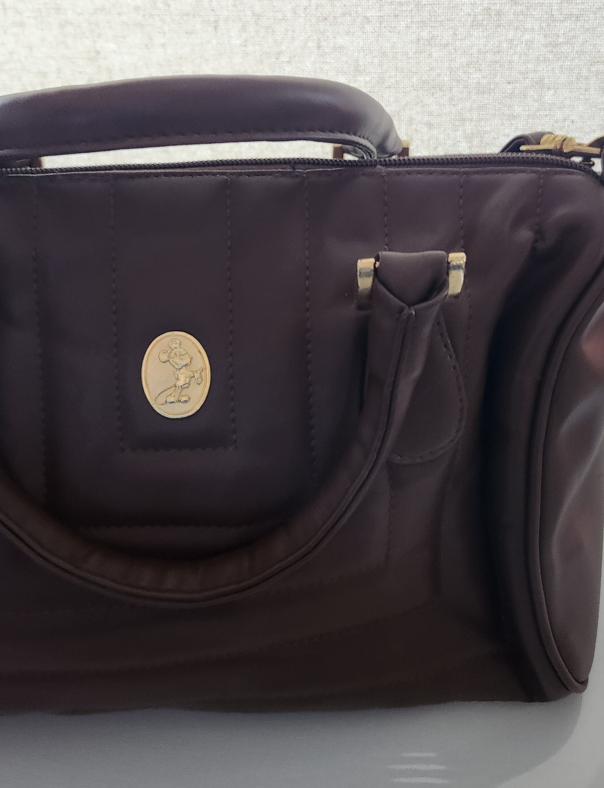 Brown hand or Shoulder Bag. Quilted exterior, associated with the Disney Brand