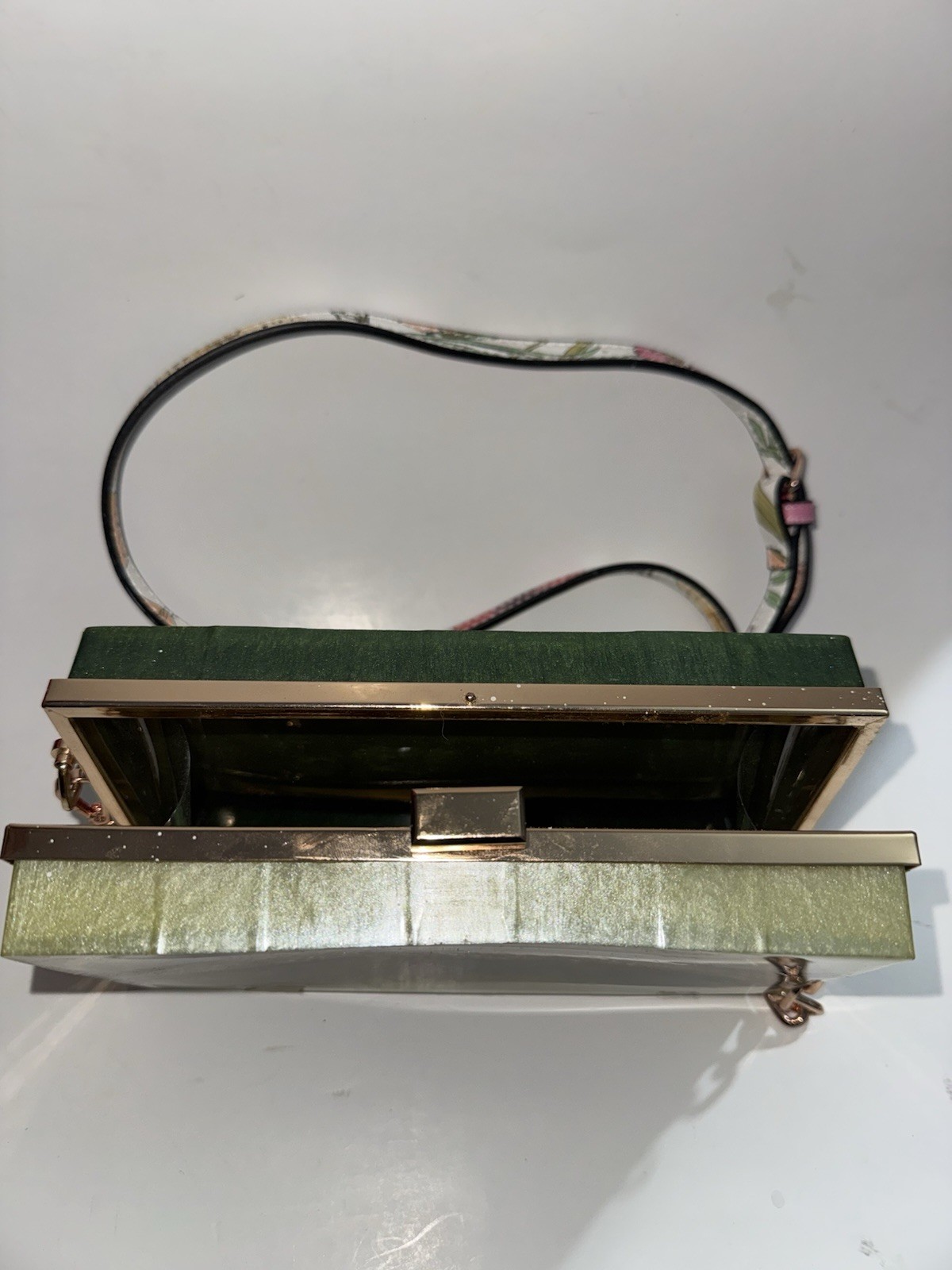 marbled acrylic box clutch bag with a gold clasp and strap