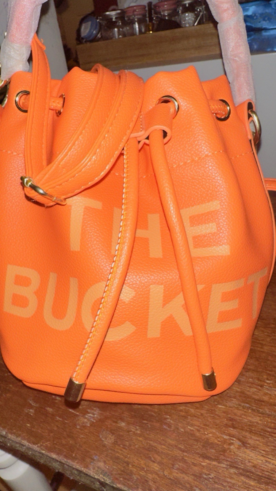 Orange Bucket Bag W Gold Accents And Drawstring Closure