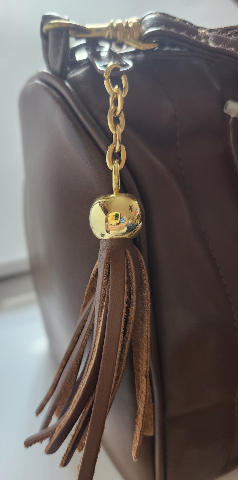 Brown hand or Shoulder Bag. Quilted exterior, associated with the Disney Brand