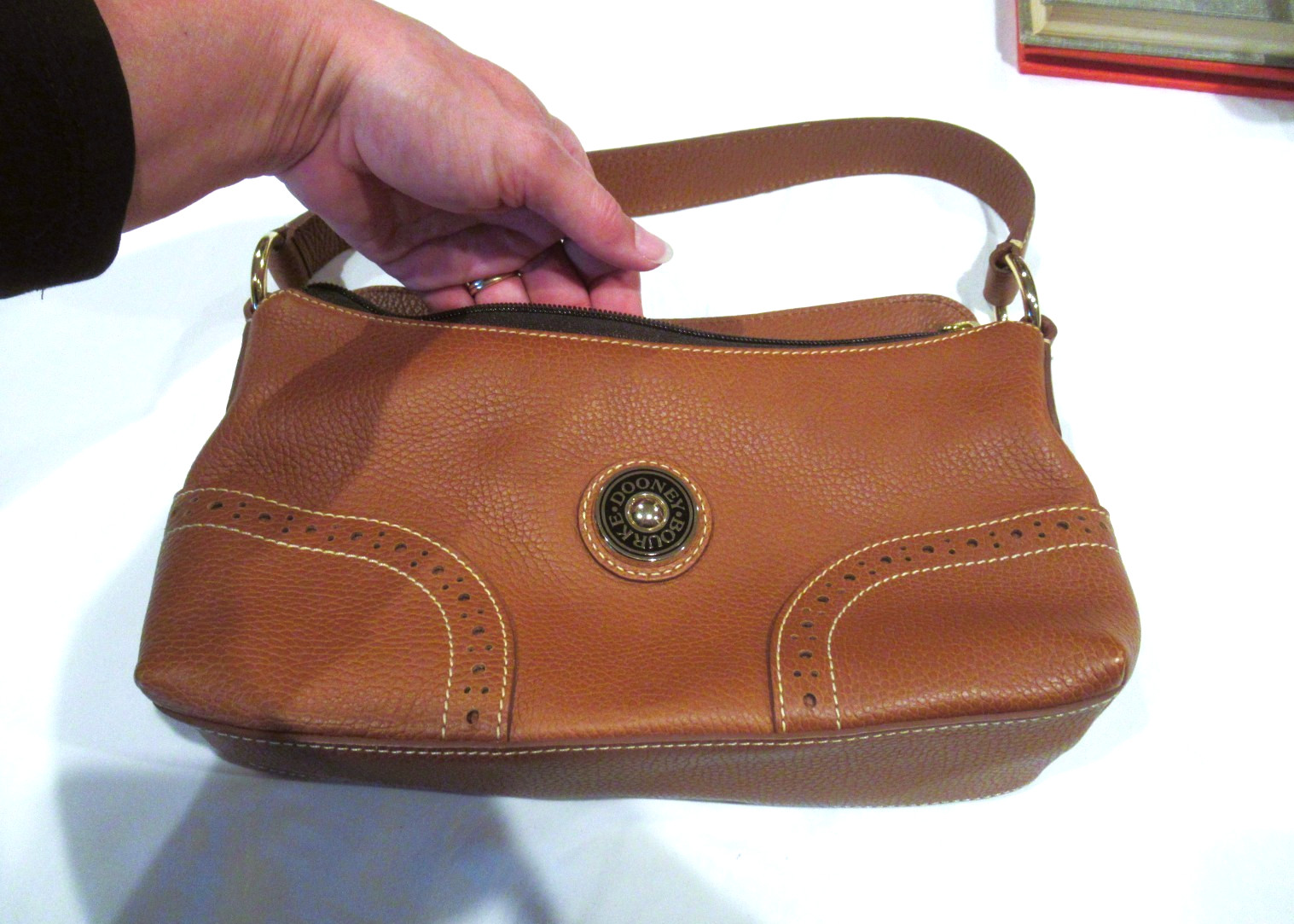 Dooney and Bourke brown leather purse, circle logo, 11 inches wide