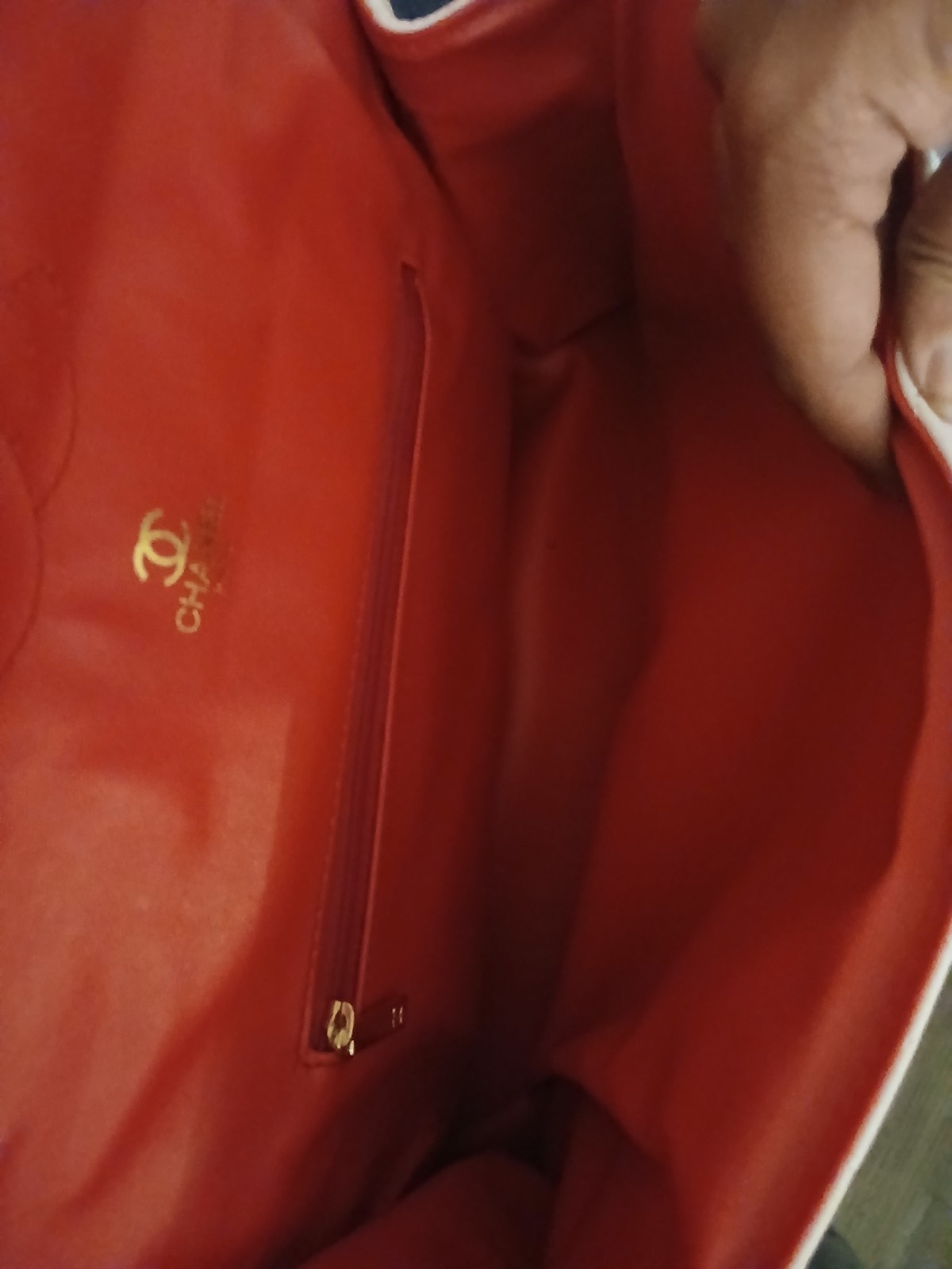 white chanel bag with red interior and a double clasp