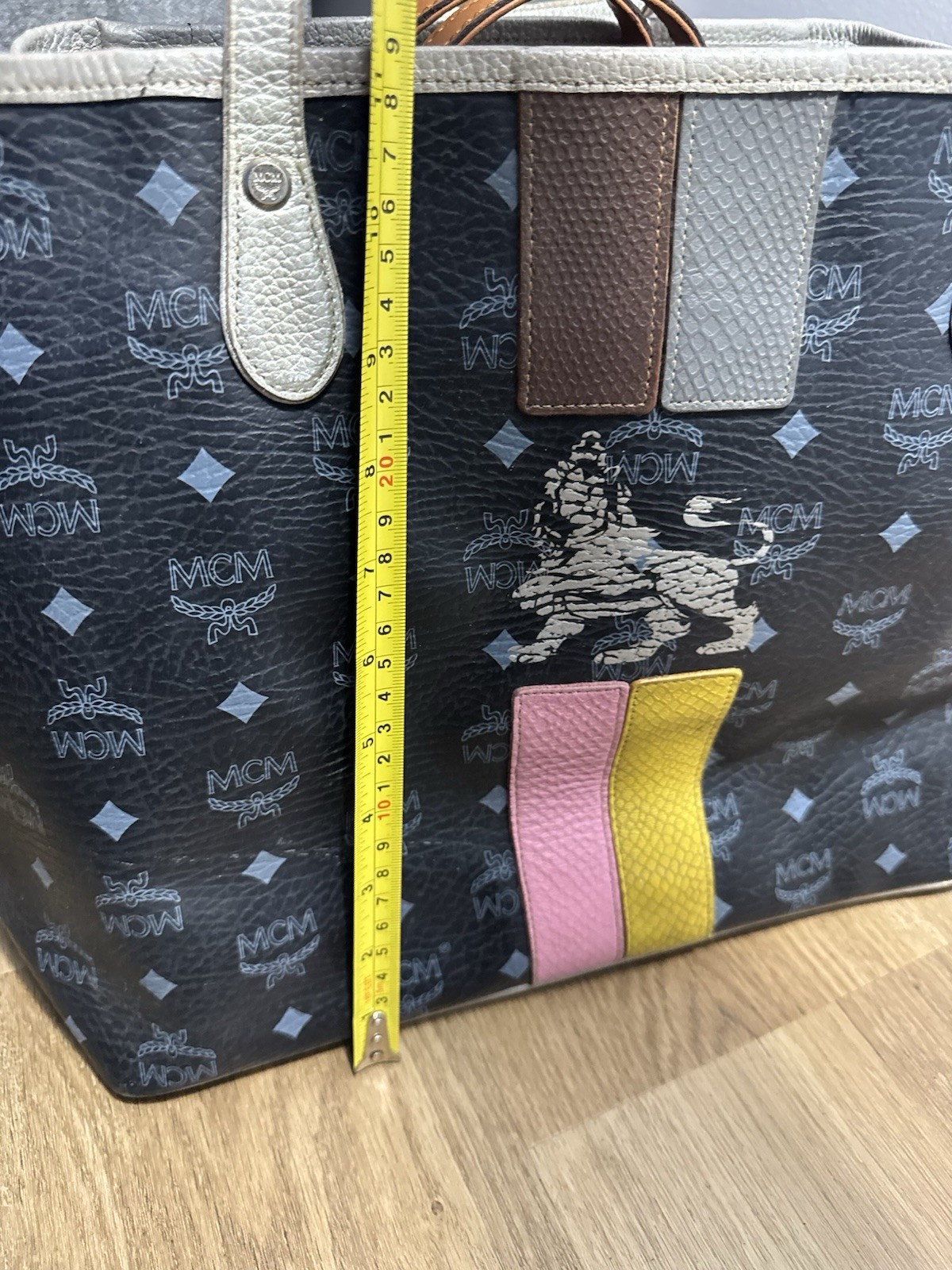 MCM black & gray tote bag with repeating white MCM logo and diamond pattern