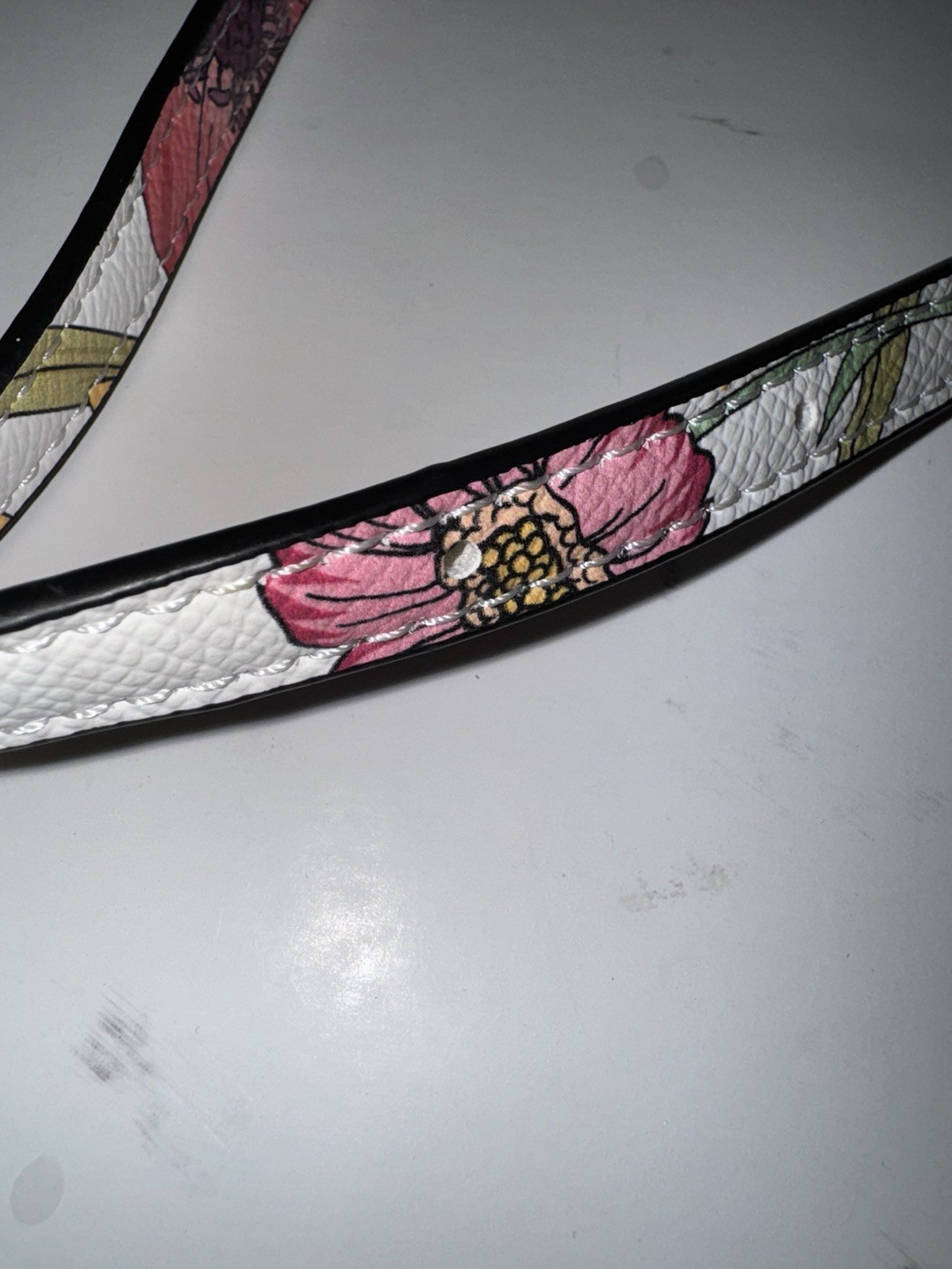 marbled acrylic box clutch bag with a gold clasp and strap