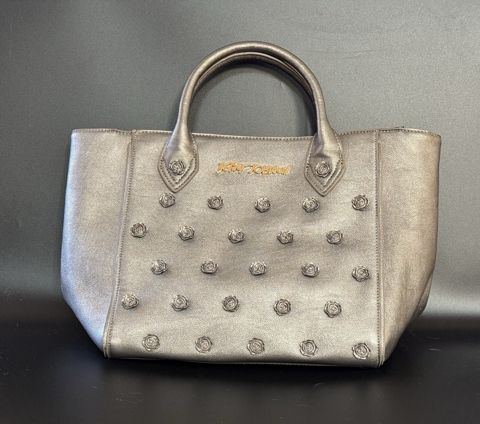 BETSEY JOHNSON SILVER ADORNED ROSES PURSE. OUTSIDE BAG 100% PU (POLYURETHANE)
