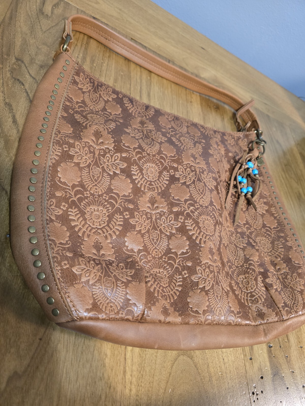 The Sak Floral Embossed Indio Leather Demi Bucket Shoulder Bag