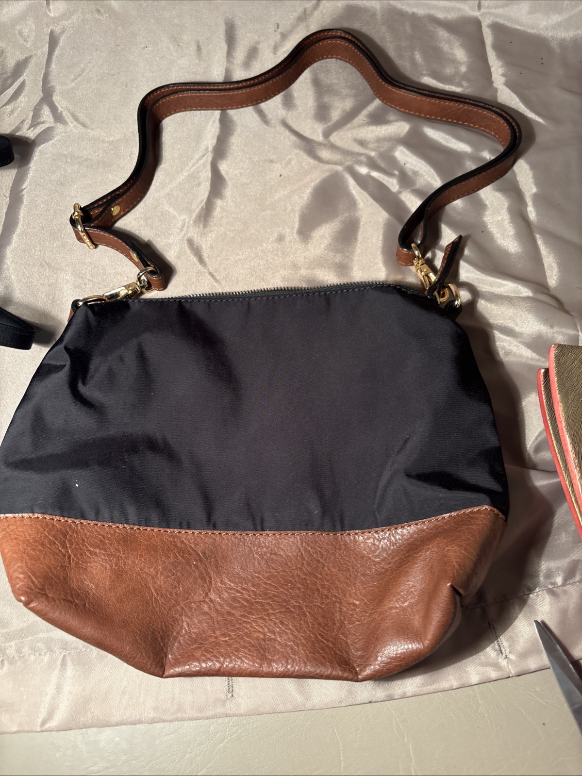 black and brown nylon and faux leather crossbody bag.