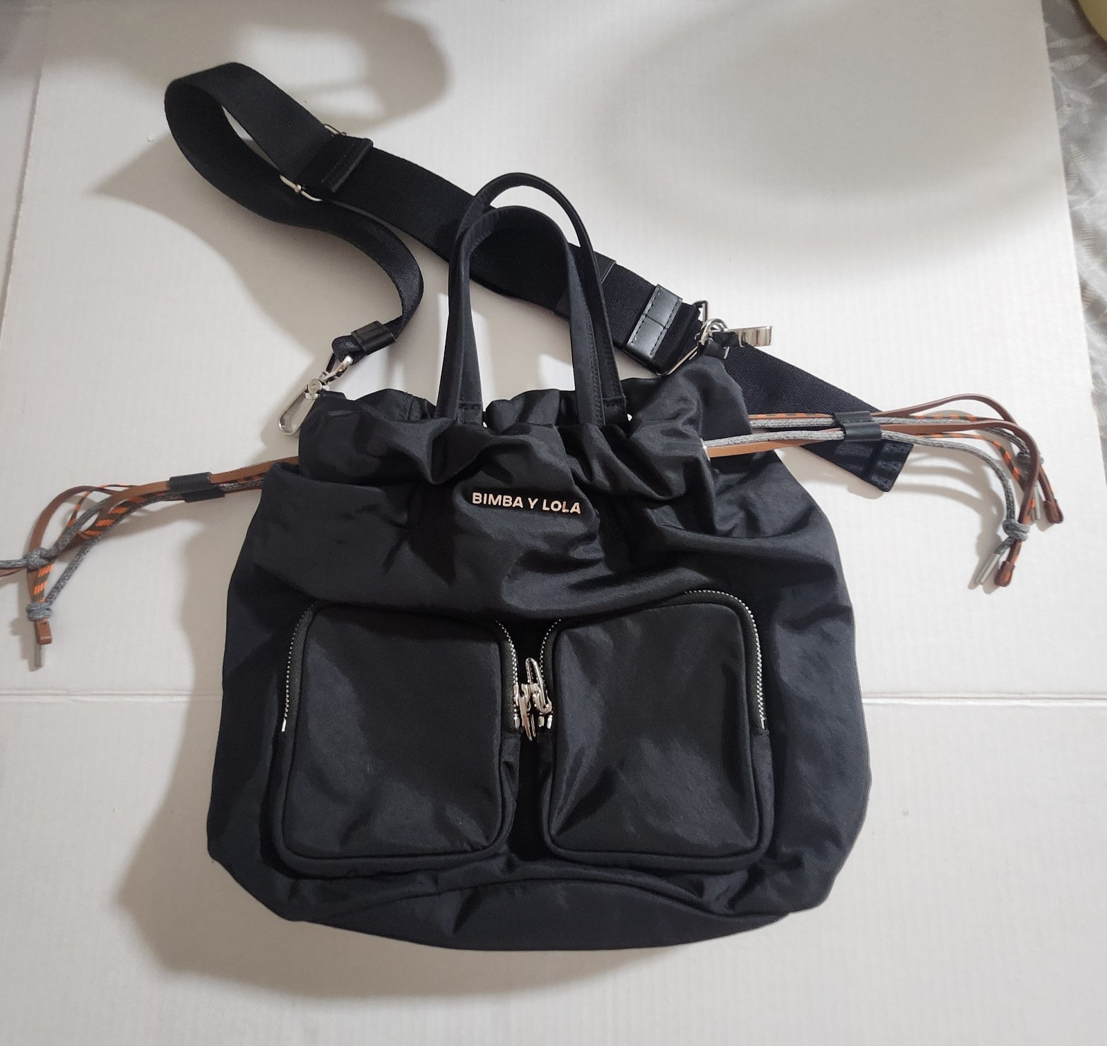 BIMBA Y LOLA Black Drawstring Bag Silver Hardware Logo Front Zip Pockets Strap