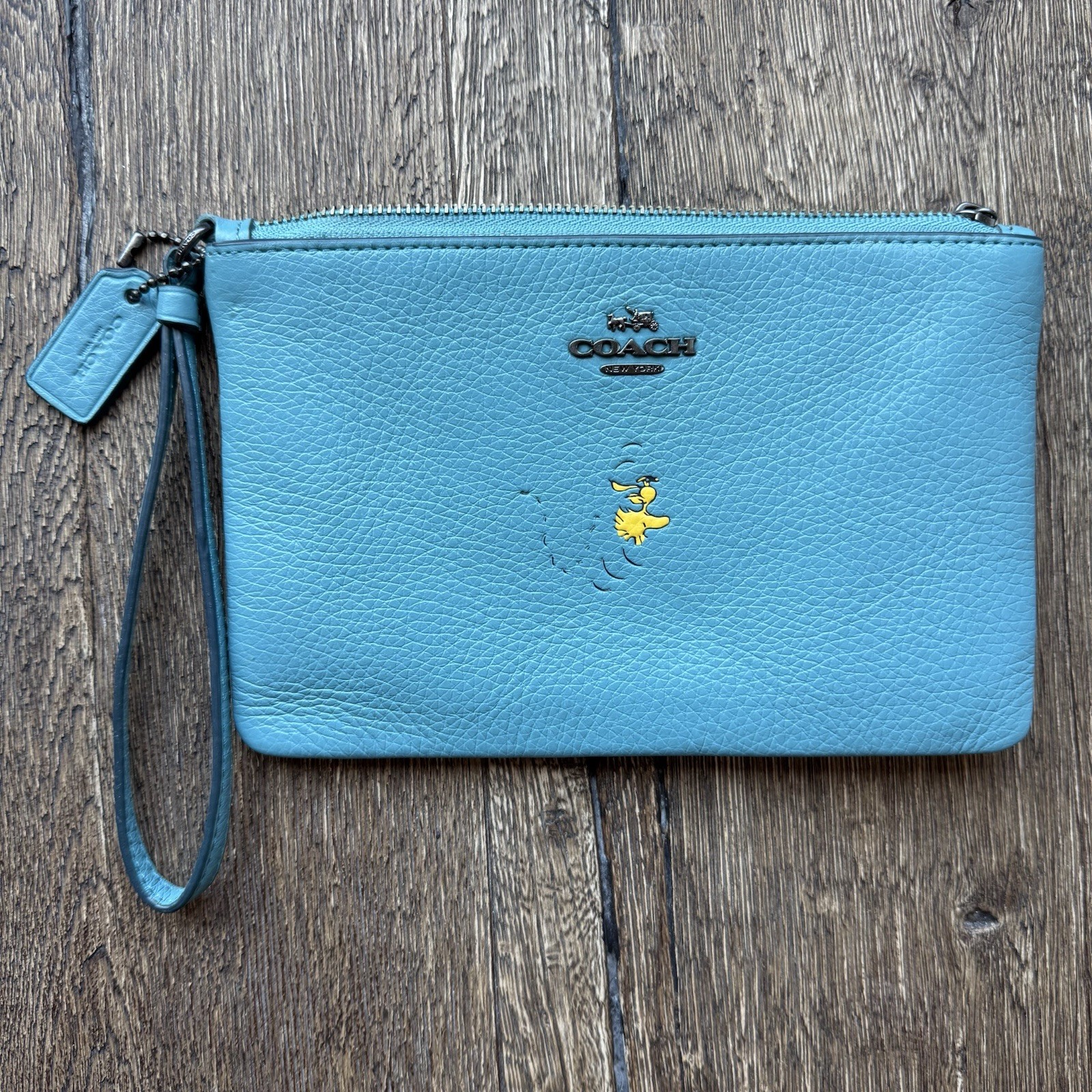 Coach x Peanuts Corner Zip Wristlet with Snoopy motif