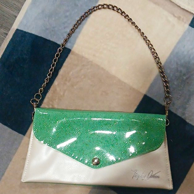Trophy Queen clutch in sparkle green and pearl with chain.