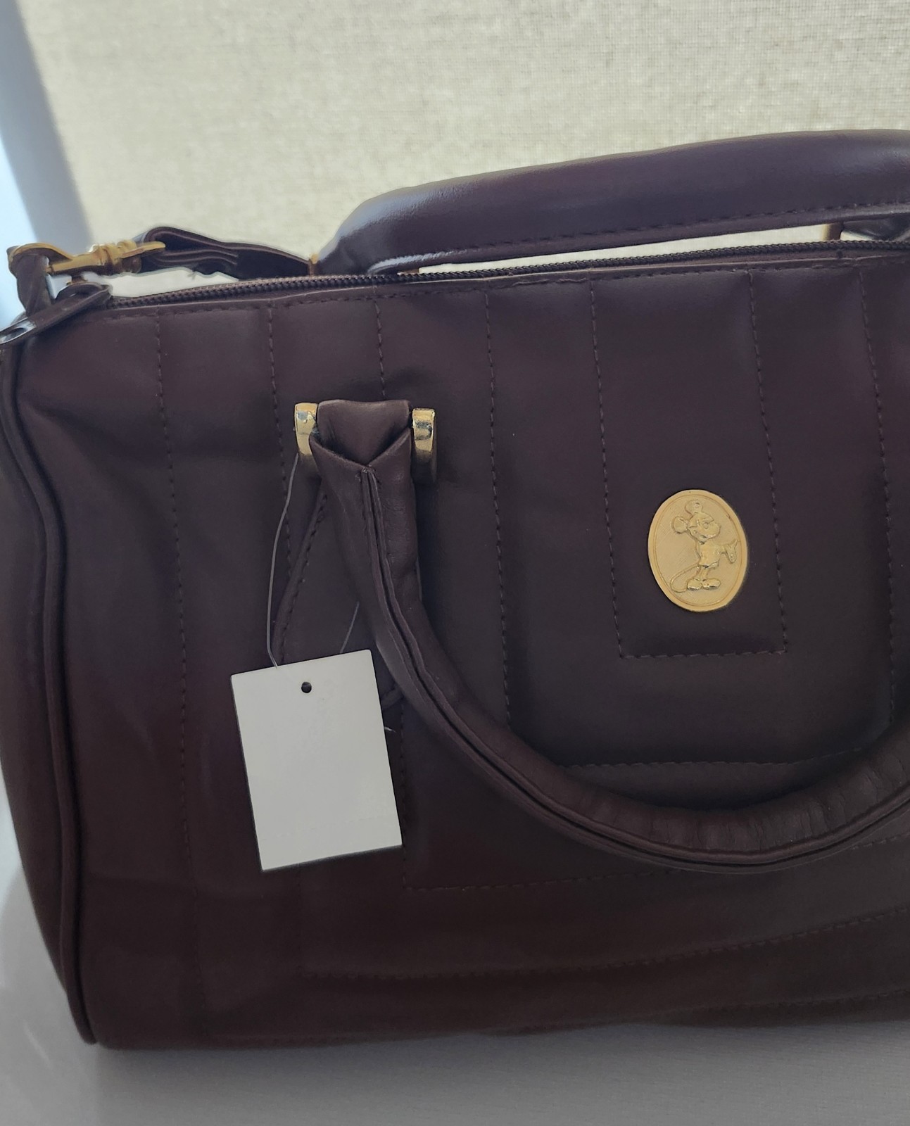 Brown hand or Shoulder Bag. Quilted exterior, associated with the Disney Brand