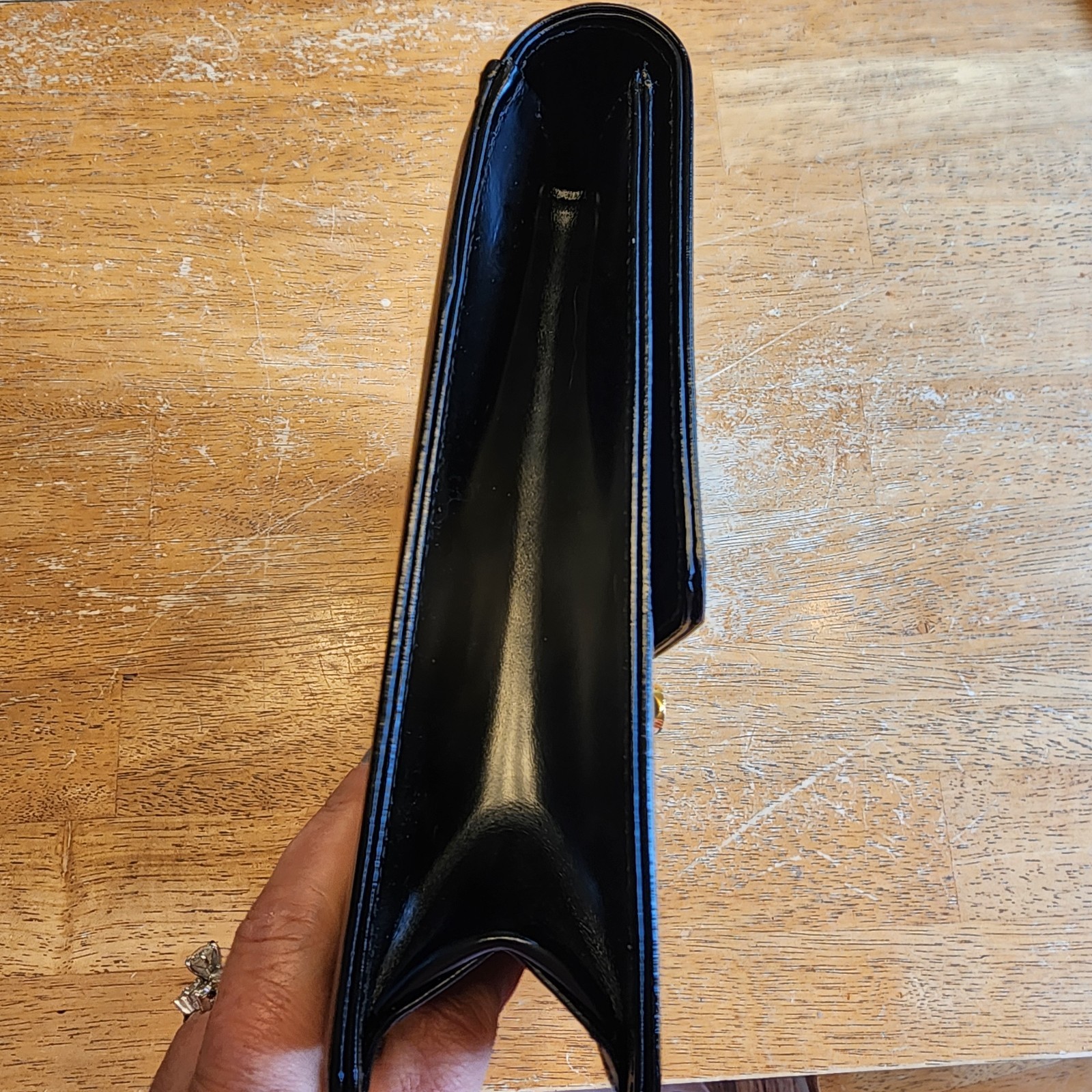 Valentino Garavani Vain clutch bag in black shiny calfskin leather