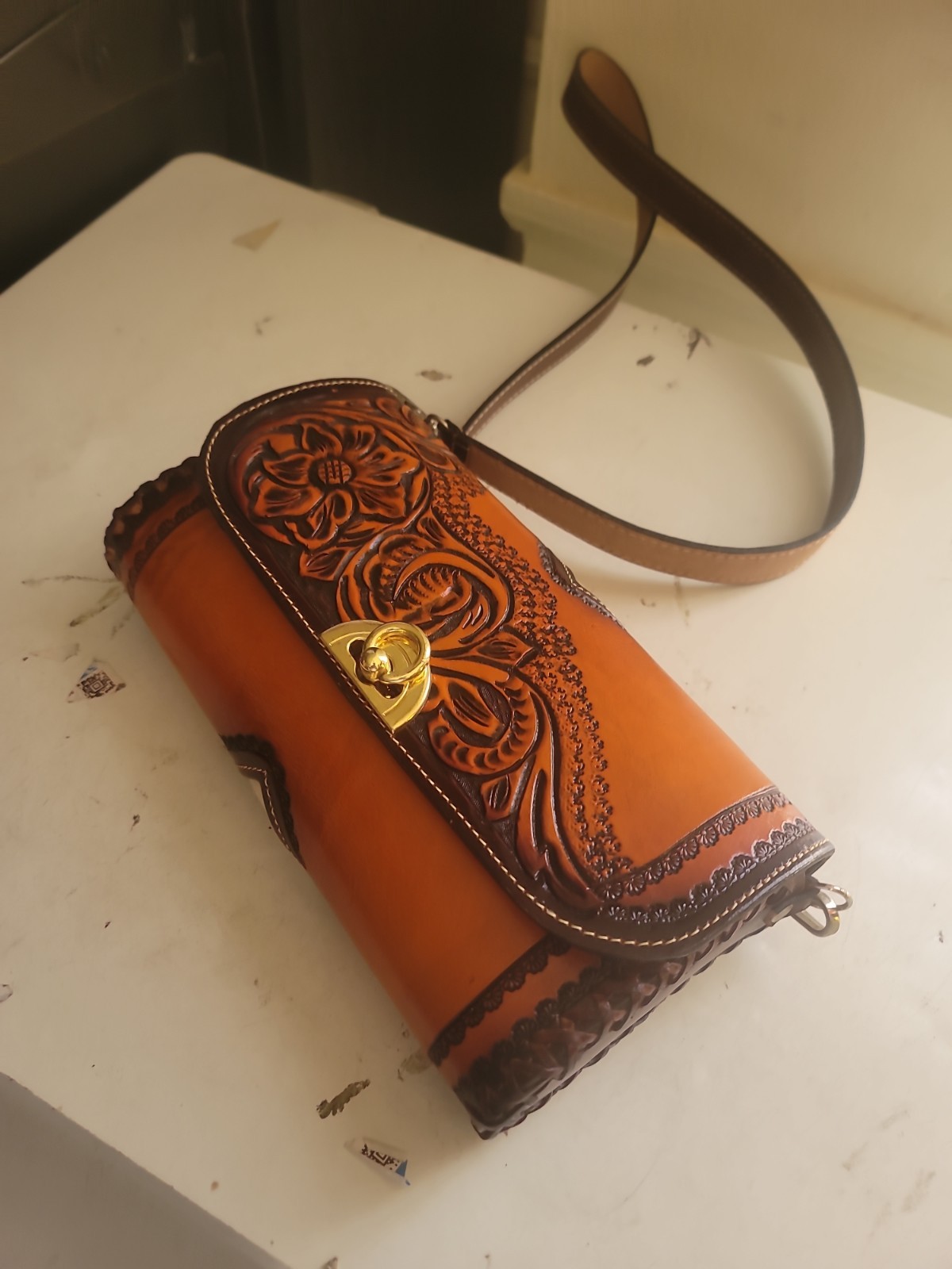 hand-tooled Western leather and hair-on-hide barrel bag