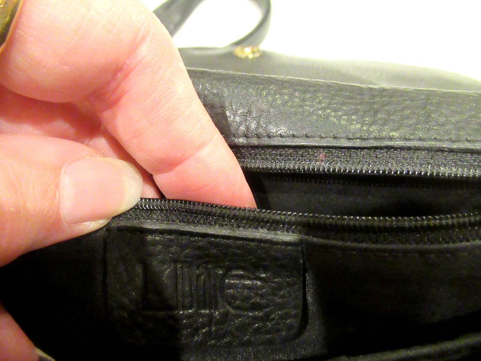 Libaire black leather purse, black interior, slot pocket on the back