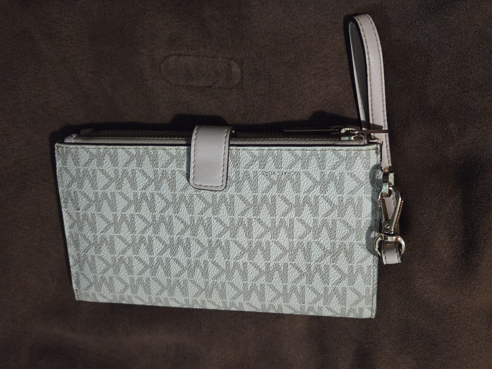 Michael Kors Jet Set Travel wristlet features the signature logo PVC monogram