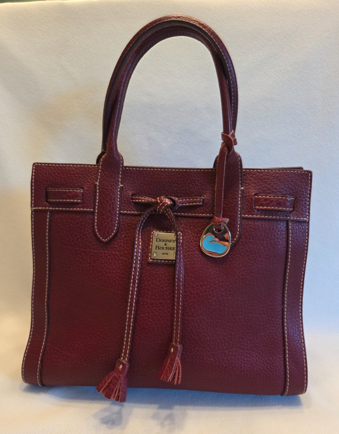 Dooney & Bourke Pebbled Leather Satchel Tote Purse w/Tassel in Burgundy 11x9x4″