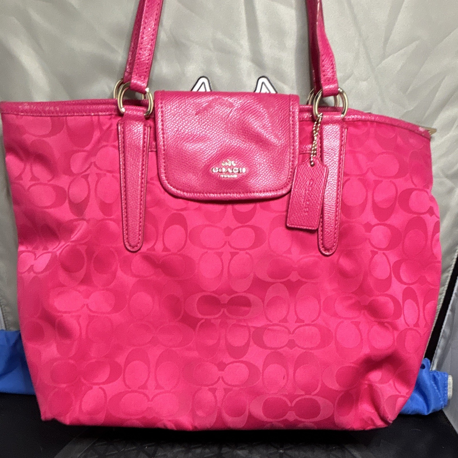 pink Coach Signature nylon tote bag shoulder straps front flap gold hardware.