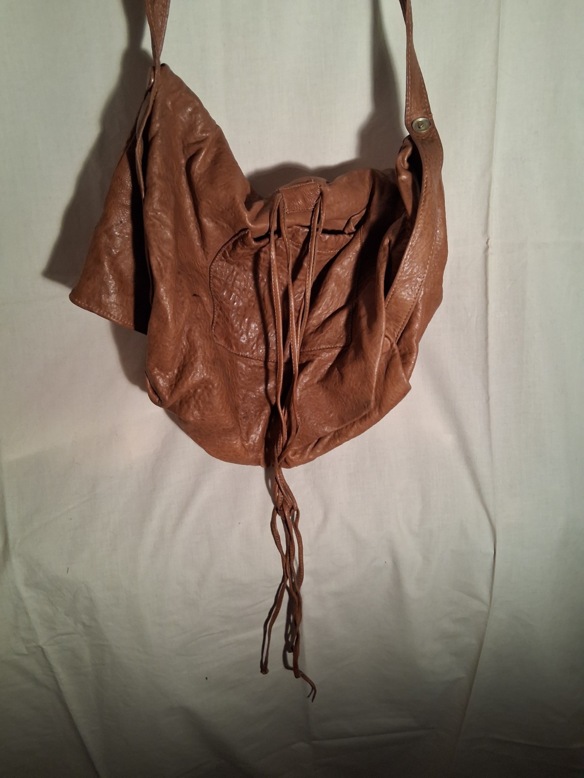 Chestnut supple leather saddlebag. 10″ high with flap closed. 16″ wide.