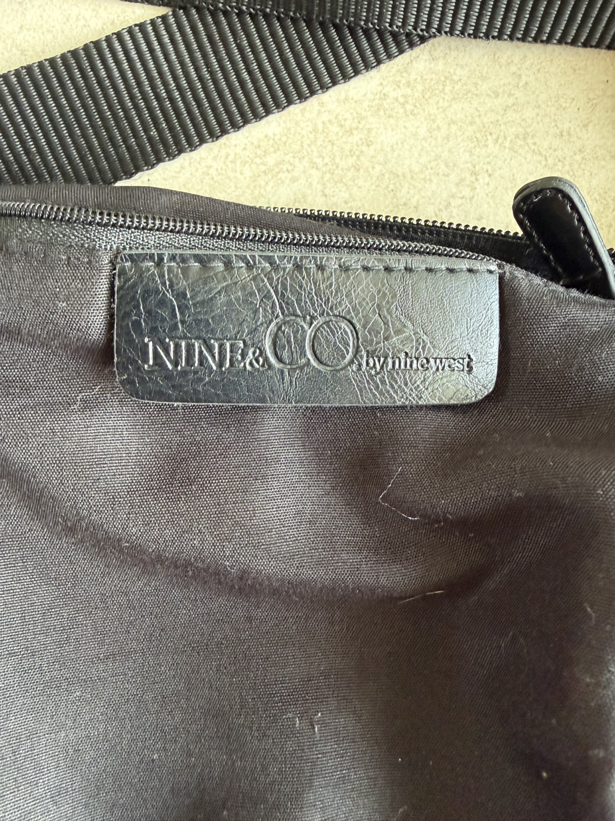 9 & Co. crossbody With outside zip pocket and outside snap pocket