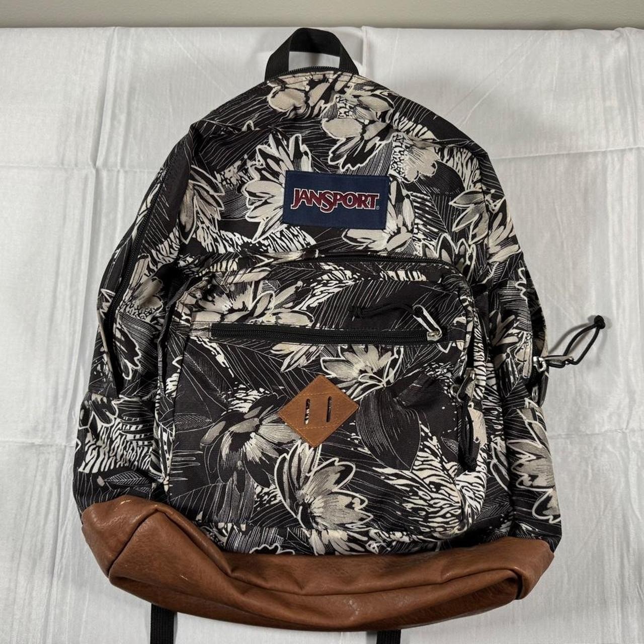 Jansport black and white floral backpack with brown accents