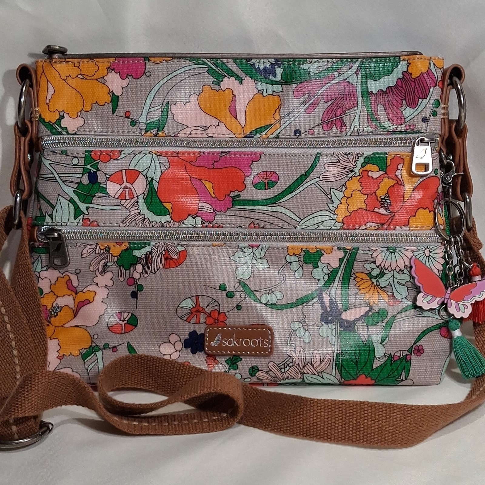 ​Sakroots Artist Circle “Flower Power” Crossbody Bag Multi Zip Coated Canvas