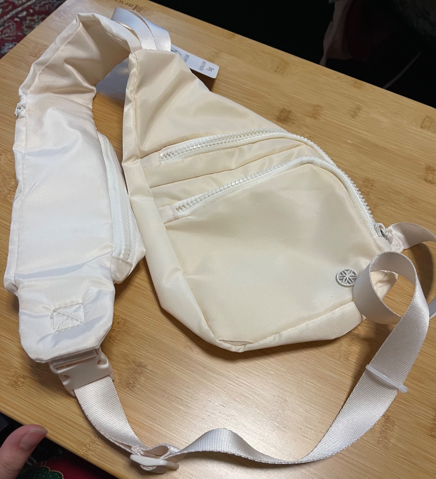 Cream colored one Shoulder travel bag woth multiple pockets and adjustable strap