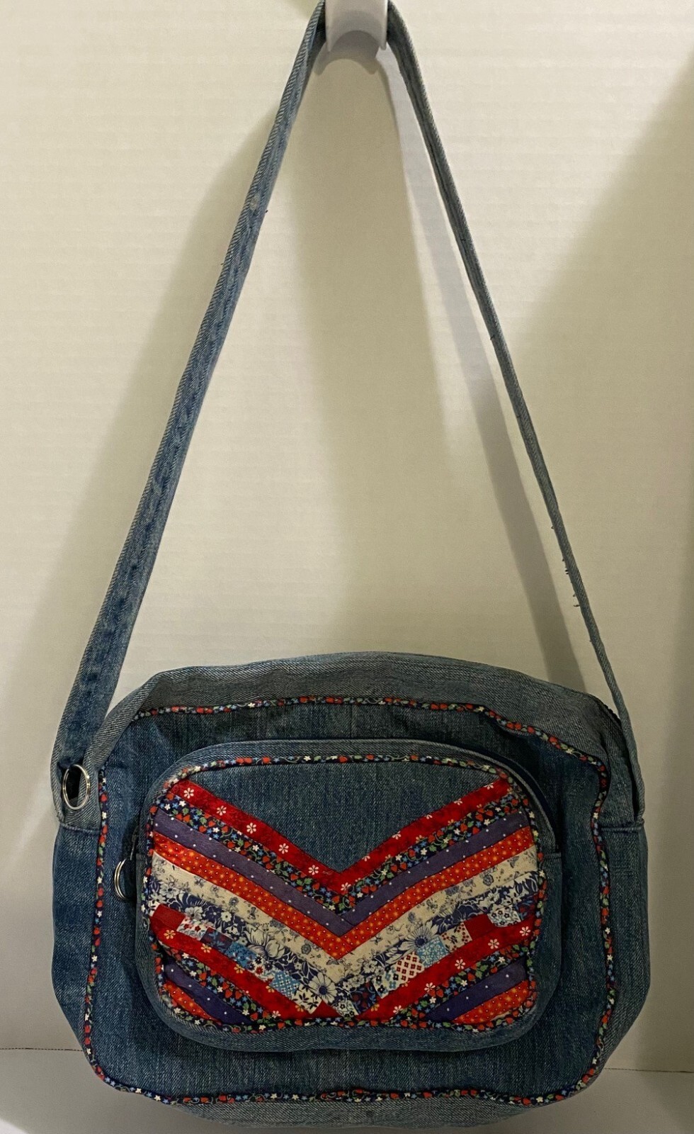 HAND MADE PURSE, FROM A PAIR OF JEANS WITH QUILTED ACCENTS ON FRONT POCKET