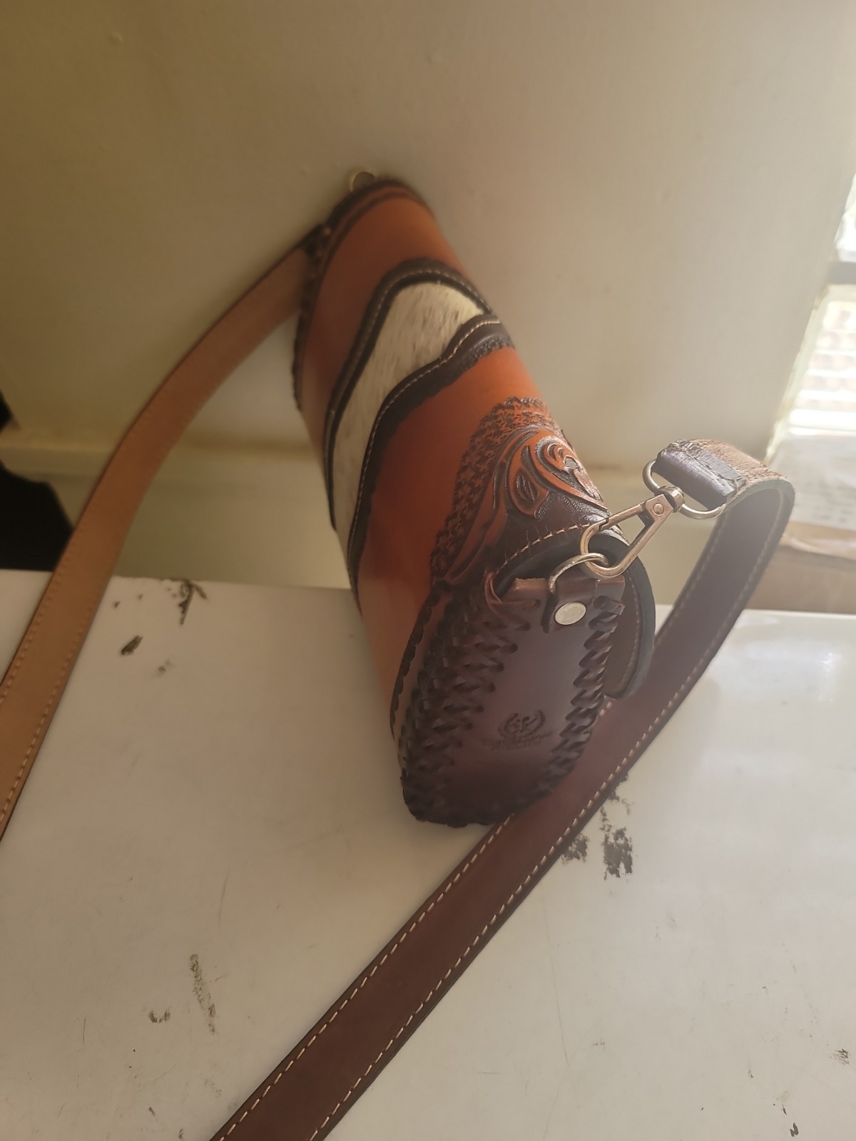 hand-tooled Western leather and hair-on-hide barrel bag