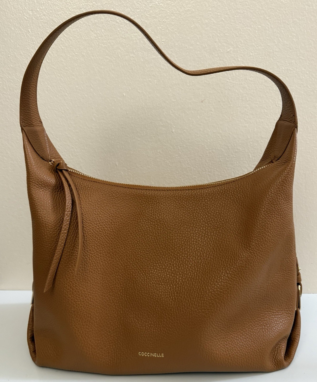 Coccinelle pebbled leather shoulder bag camel color