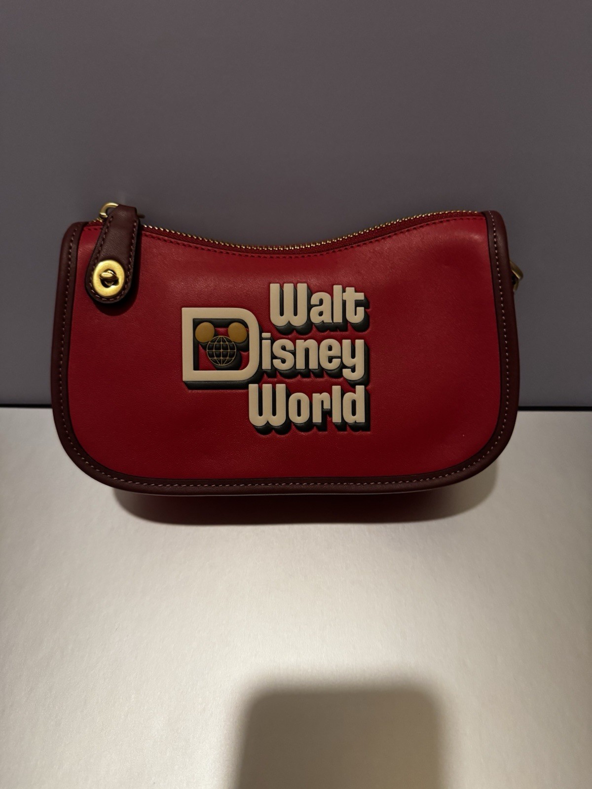 DISNEY X COACH SWINGER 20 WITH WALT DISNEY WORLD MOTIF ELECTRIC RED ULTRA RARE