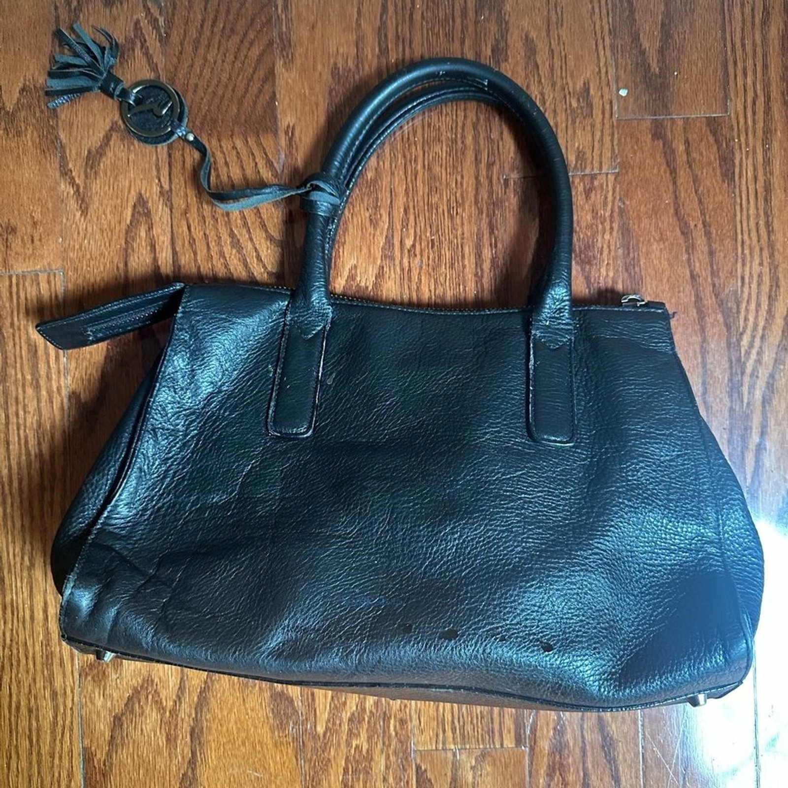 Varriale black pebbled leather satchel a distinctive tassel charm