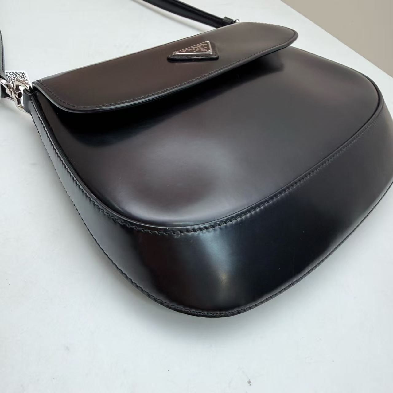 Prada Cleo Small Black Brushed Leather Saddle Bag with Silver Triangle Logo