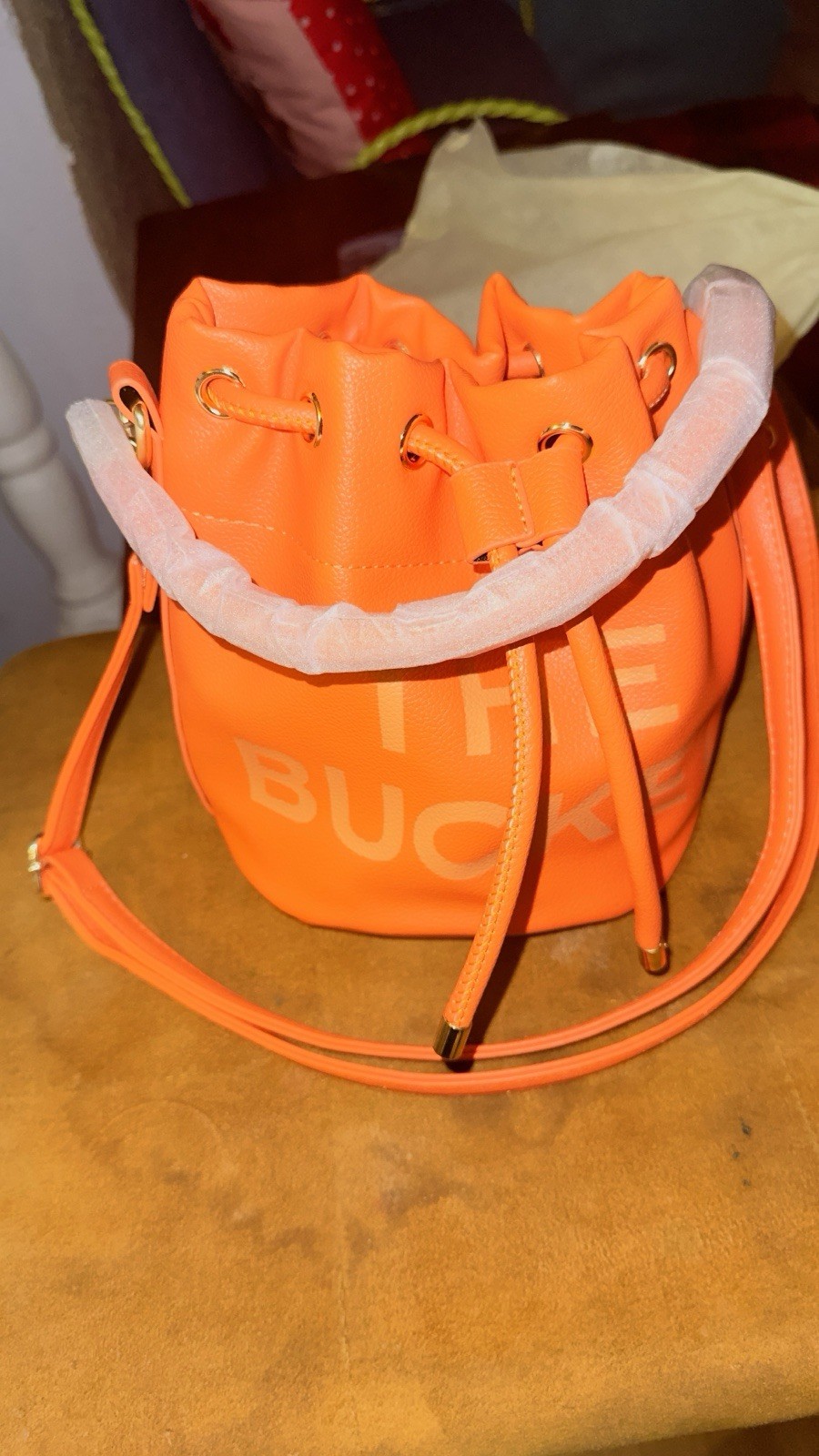 Orange Bucket Bag W Gold Accents And Drawstring Closure