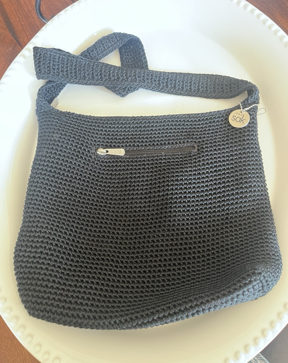 The Sak Black Shoulder Bag Zip Closure w/ Bag Charm Lined Inner Pockets