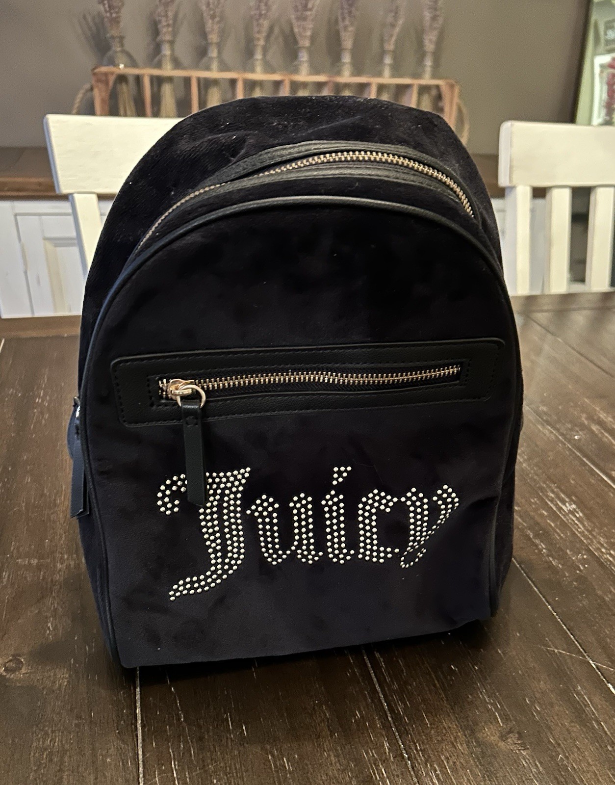 Juicy Couture mini backpack features a sparkling rhinestone “Juicy” logo